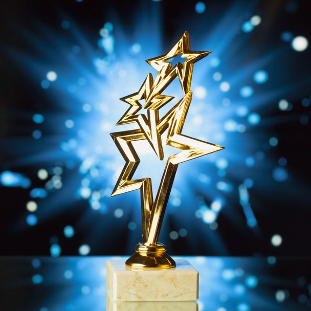 gold stars trophy against shiny sparks background - Foto, immagini