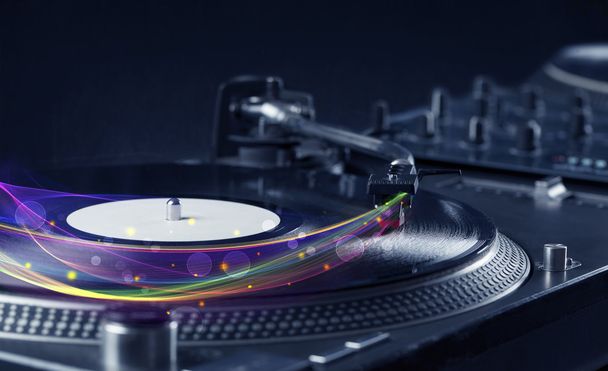 Turntable playing vinyl with glowing abstract lines - Photo, Image