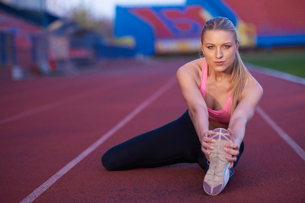 sporty woman on athletic race track - Fotoğraf, Görsel
