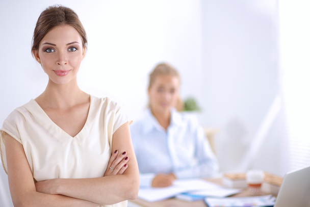 Attractive young businesswoman standing  near desk in office - Foto, Imagem