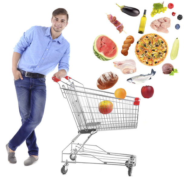 Young man pushing shopping cart - Photo, Image