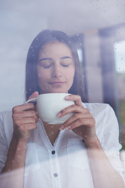 beautiful young woman drink first morning coffee at modern home interior - Foto, Bild