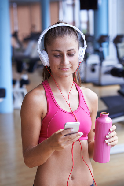 woman with headphones in fitness gym - 写真・画像