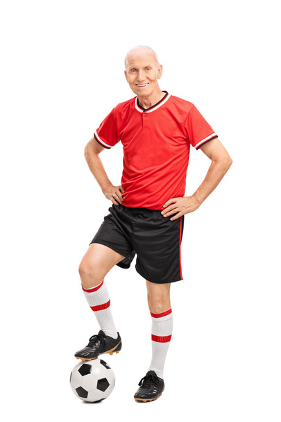 Senior man in a football jersey with ball - Фото, зображення