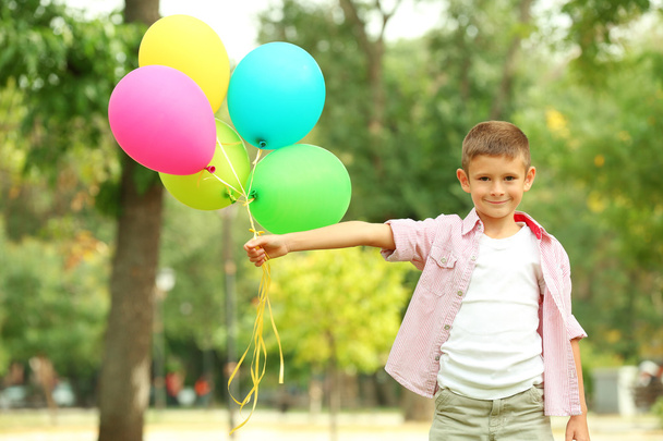 Little boy with balloons  - Фото, изображение
