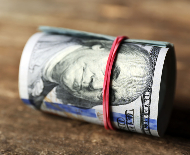 Dollars roll on wooden background - Zdjęcie, obraz