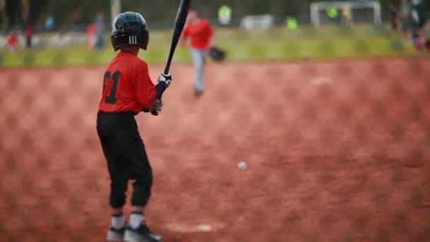 Cool shot de un niño bateando en un juego de béisbol
 - Imágenes, Vídeo