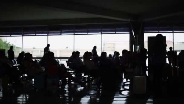 Σιλουέτες των ανθρώπων που περιμένουν στο τερματικό σταθμό του αεροδρομίου - Πλάνα, βίντεο