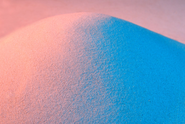 A színesen megvilágított homok háttér - Fotó, kép