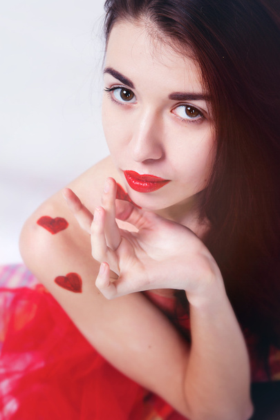 Brunette girl with red hearts - Zdjęcie, obraz