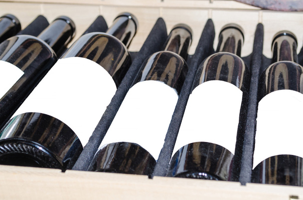 Viini valkoisella etiketillä varustetuissa pulloissa
 - Valokuva, kuva