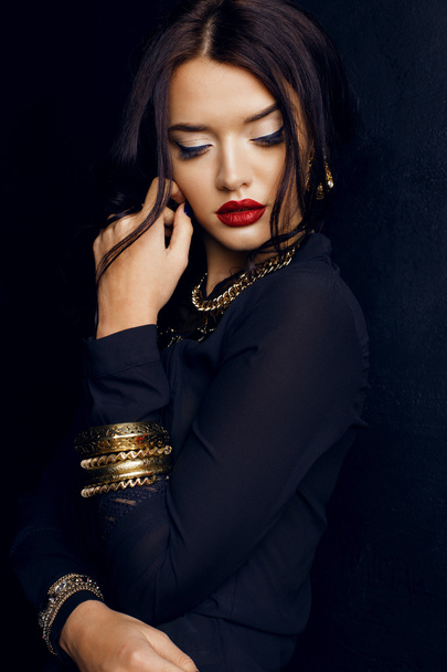 gorgeous woman with dark hair and bright makeup with luxurious bijou - 写真・画像