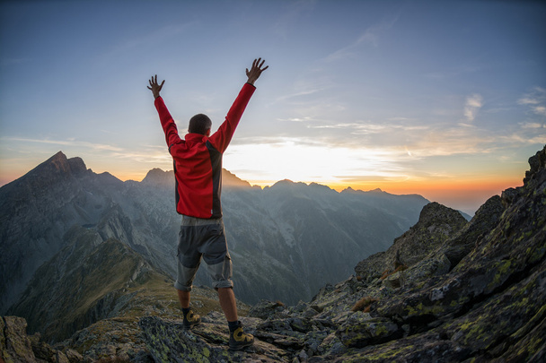 Hiker celebrating success in the sunset - Photo, Image