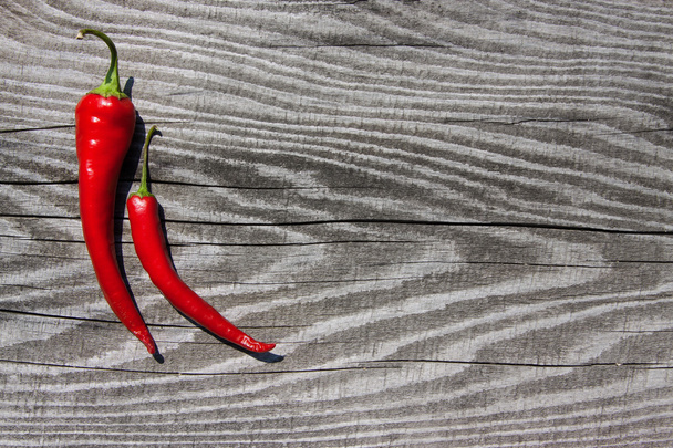Red pepper on a wooden texture - Fotoğraf, Görsel