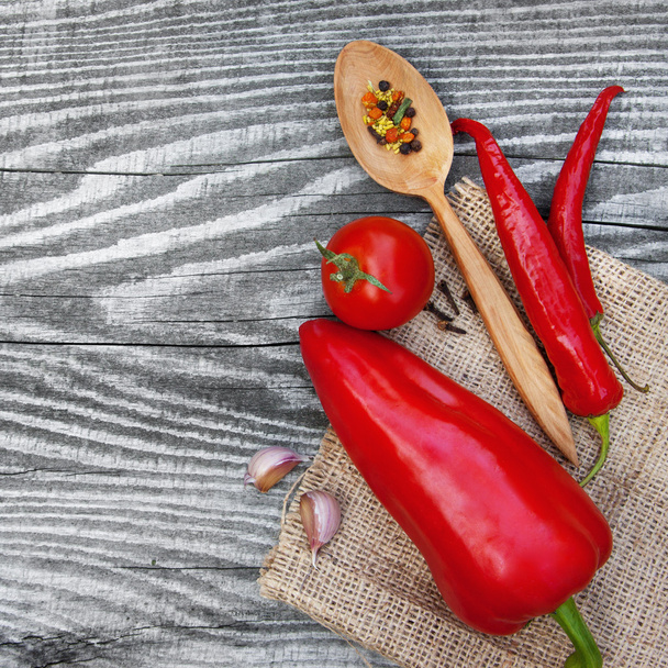 Red pepper and vegetables on wooden texture - Foto, Imagem