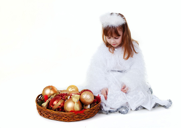Little girl in christmas clothes with toy - Foto, afbeelding