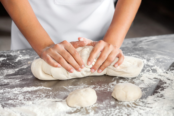 Midsection Of Female Baker Kneading Dough - Foto, imagen