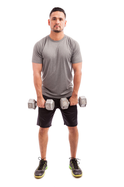 man in sporty outfit raising dumbbells - Photo, Image