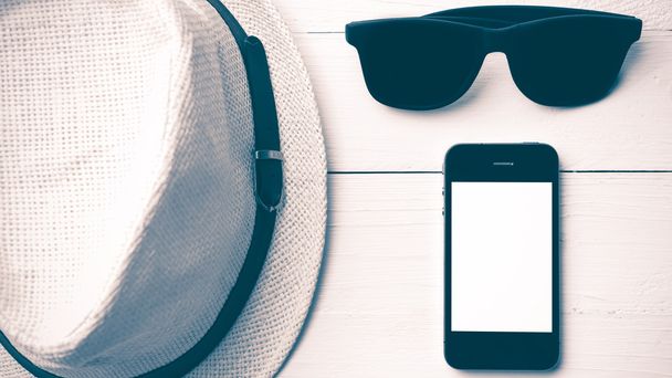 hat sunglasses and smart phone vintage style - Фото, изображение
