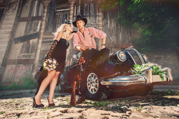 Couple outdoors near old-fashioned car - 写真・画像