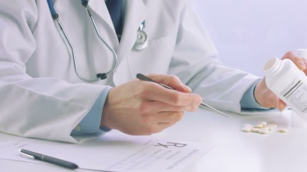 Male doctor hands writing prescription paper - Кадри, відео