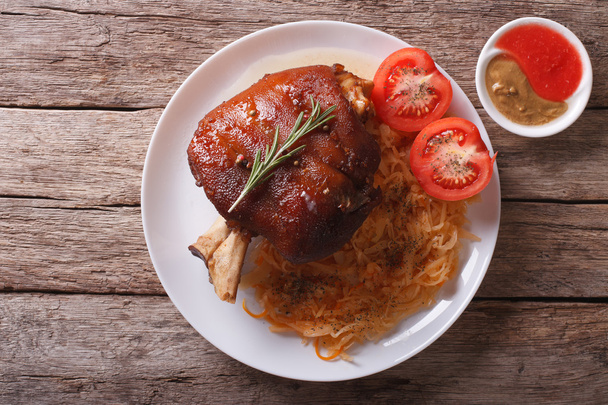 pork shank, sauerkraut and sauce. horizontal top view - Photo, Image