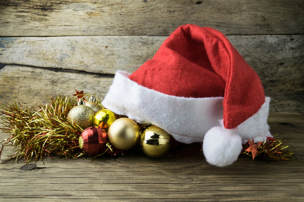 Santa Hat with Christmas decorations on old wooden background. - Photo, Image