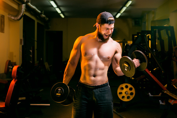 man in gym training with dumbbells - Zdjęcie, obraz