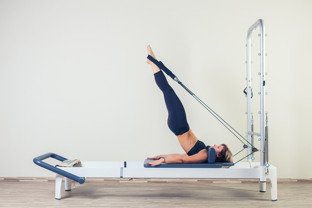 Pilates reformer workout exercises woman brunette at gym indoor - Photo, Image