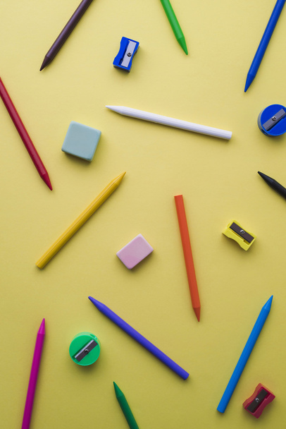 Crayons, pencil sharpeners and erasers of different colors - Fotografie, Obrázek