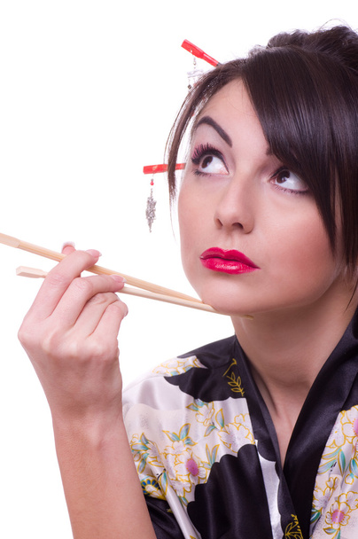 Молодая женщина в японском кимоно с палочками для еды
 - Фото, изображение