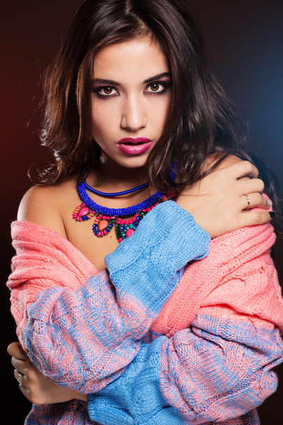 Girl is wearing warm colorful sweater and jewelry - Fotografie, Obrázek