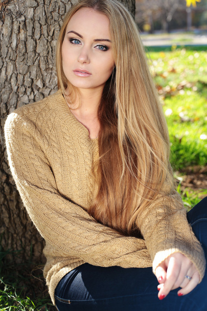 blond woman in autumn park - 写真・画像