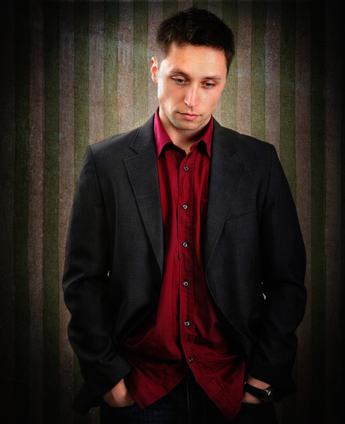 Young stylish man on vintage wallpaper background - Foto, Imagen