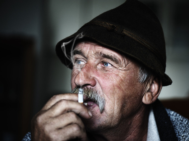 Closeup Artistic Photo of Aged Man With Grey Mustache Smoking, grain added - Фото, изображение