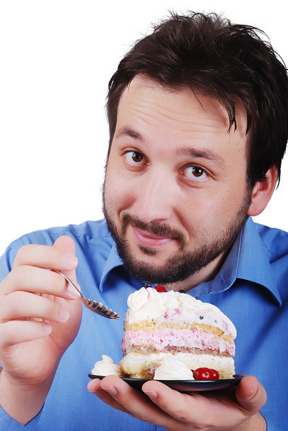 Young man eating colorful cake, isolated - Φωτογραφία, εικόνα