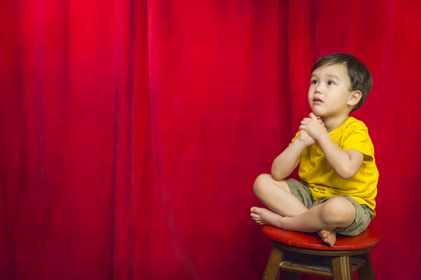 Mixed Race Boy Sitting on Stool in Front of Curtain - Photo, Image