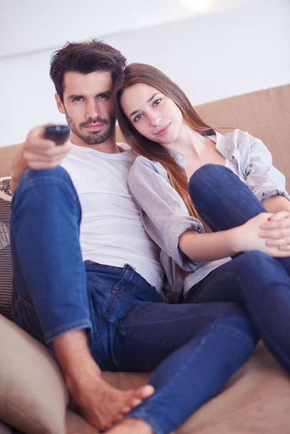 young couple watching tv at home - Photo, image