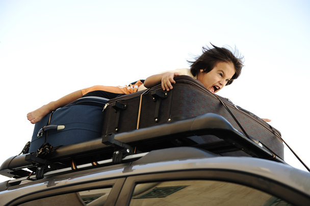 Little boy traveling on the top of the car - 写真・画像