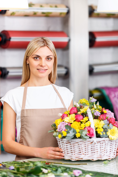 Professional florist working in a flower shop - Photo, image