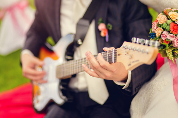 the groom plays guitar - Photo, Image