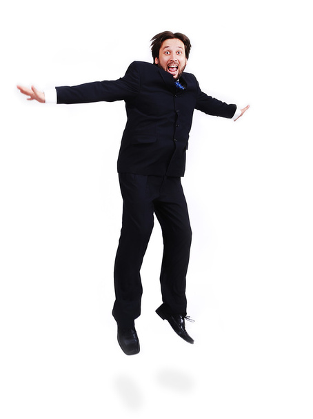 Jovem homem atraente vestindo terno e pulando para cima
 - Foto, Imagem