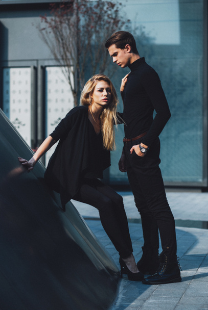 Jeune homme et femme à la mode posant dans la rue architecte moderne
 - Photo, image