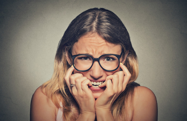 stressed anxious young woman girl in glasses student biting fingernails - Foto, imagen