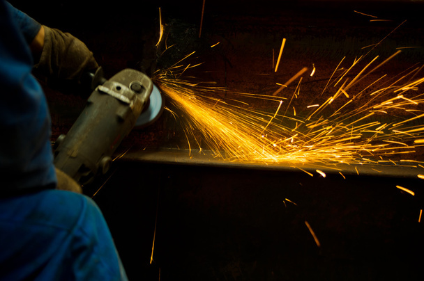 Working cutting rod with saw creating sparks - Foto, Imagem