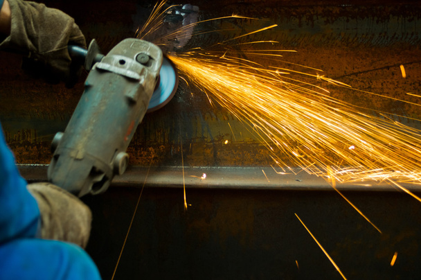 Working cutting rod with saw creating sparks - Foto, Imagen