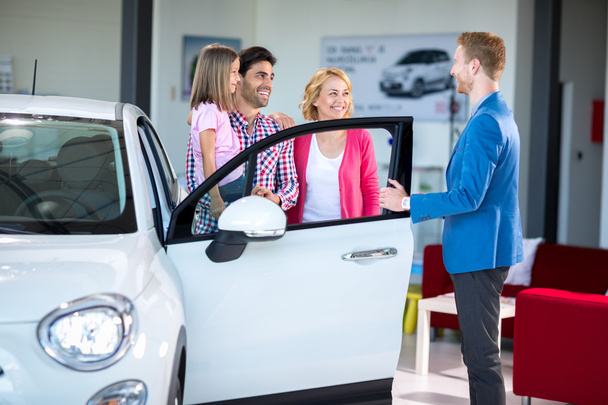 Cheerful family in car showroom - Photo, image