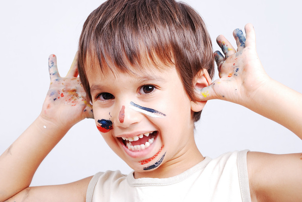 Little cute kid with colors on his face - Φωτογραφία, εικόνα