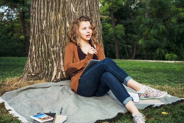 young caucasian female student with books on campus, student study in campus area - Foto, imagen