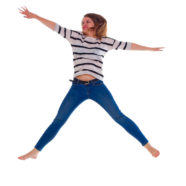 young woman in jeans jumping - Foto, afbeelding